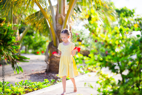 Adorable little girl during beach vacation in luxury resort