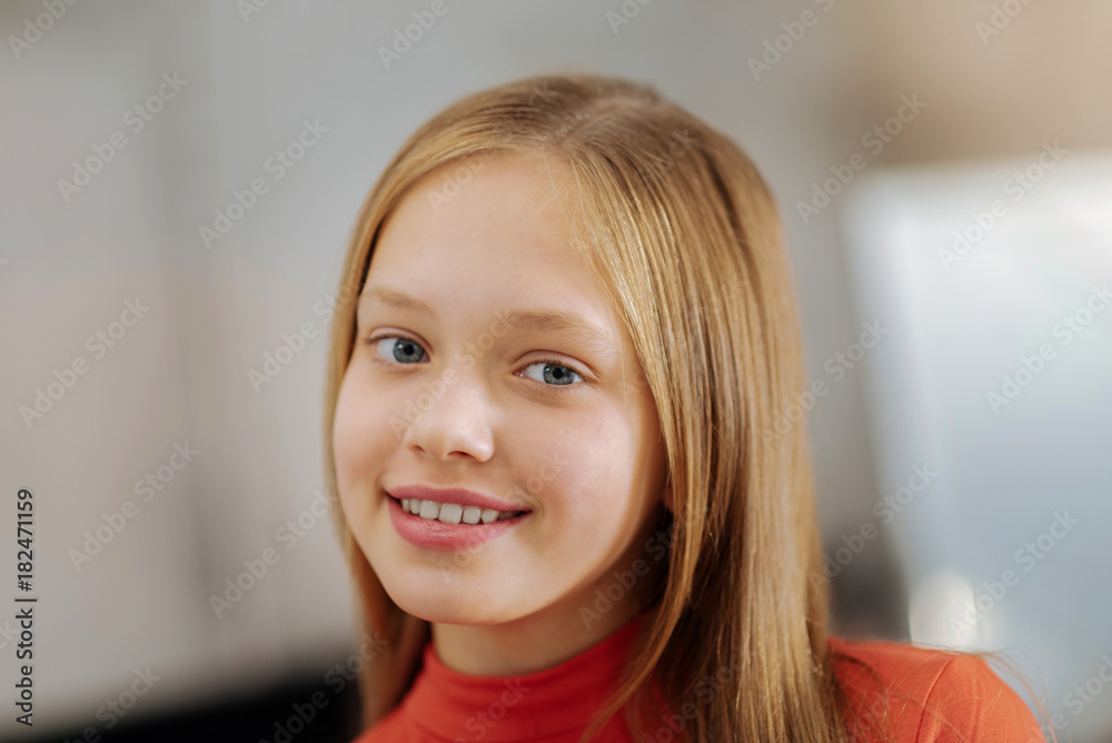 Friendly and open minded. Portrait of a happy positive cute girl smiling to you and feeling happy while being in a positive mood Friendly and open minded. Portrait of a happy positive cute girl smiling to you and feeling happy while being in a positive mood