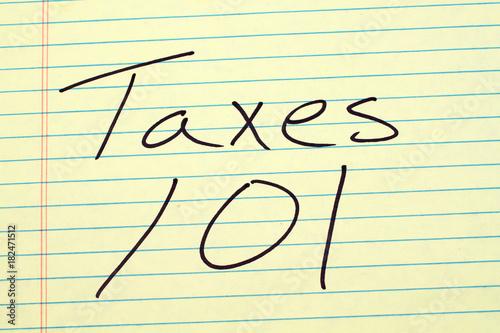 The words "Taxes 101" on a yellow legal pad