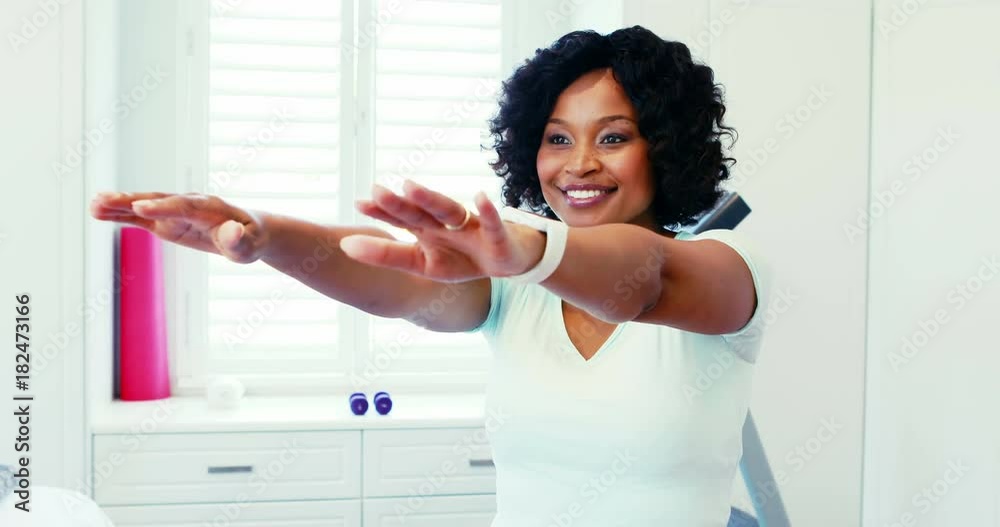 Woman performing stretching exercise at home Woman performing stretching exercise at home