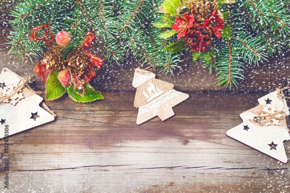 Fototapeta premium Christmas decorations on oldboards. Christmas background. New Year background. Xmax background. Christmas tree. Snow falls.
