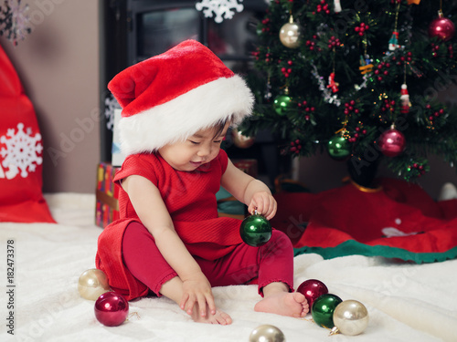 baby girl  decorating Christmas tree photo