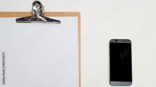 top view paper board with smarth phone and keyboard white background