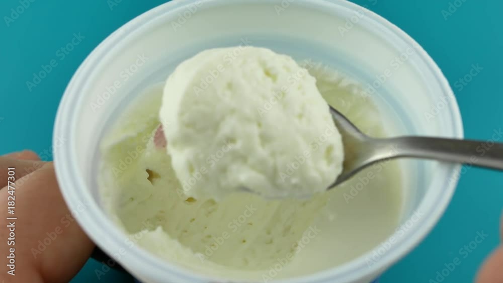 Eating healthy white yoghurt on spoon. Concept of healthy food nutrition. Eating healthy white yoghurt on spoon. Concept of healthy food nutrition.