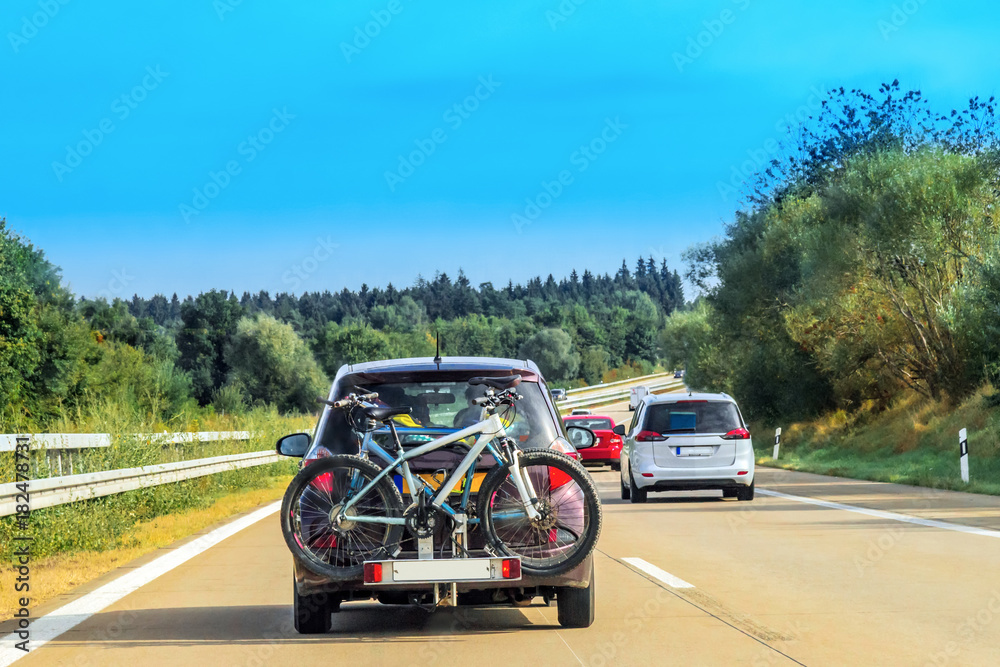 Car with bicycles in highway in Switzerland