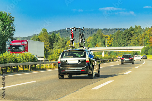 Car with bicycles in highway of Switzerland