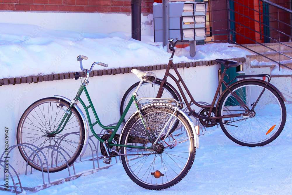 Bicycles parked at snowy street of winter Rovaniemi