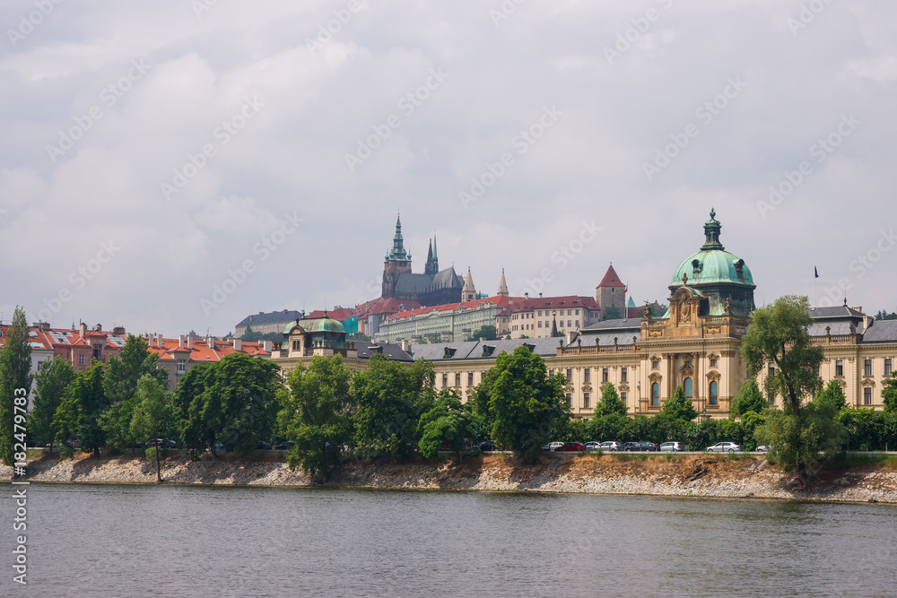 Vltava River embankment with Prague Old Town Strakova Academy