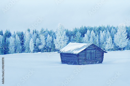 Wooden shed in winter countryside at Lapland