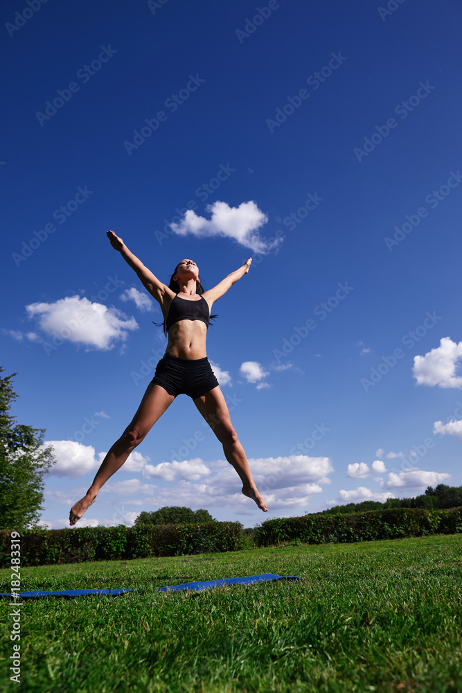 The girl in the Park, jumping up on the background of clear sky. The girl in the Park, jumping up on the background of clear sky.