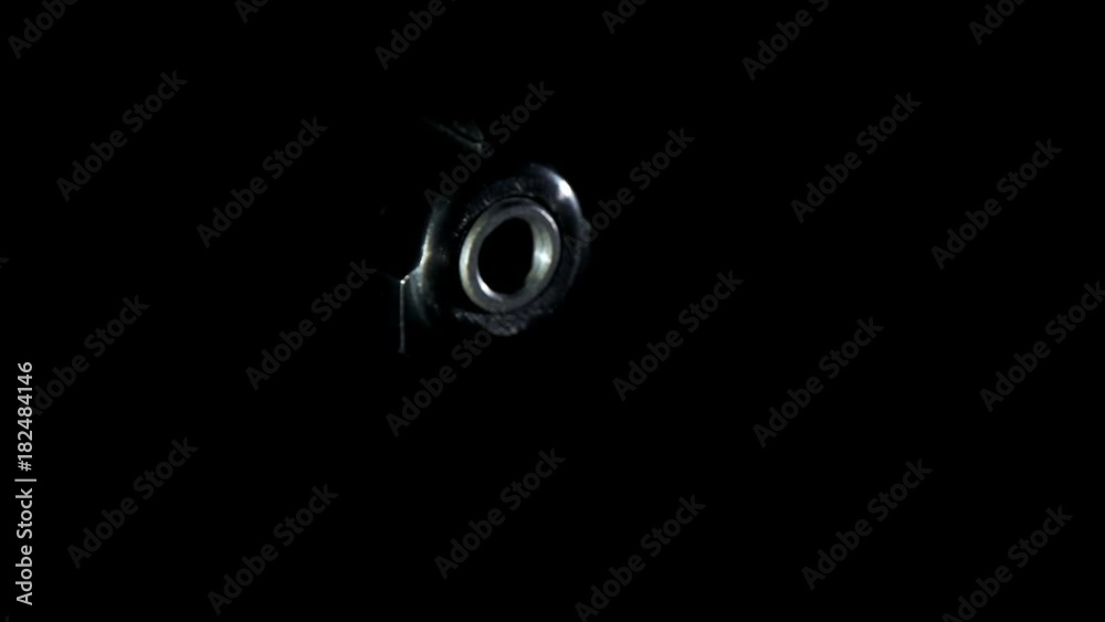 the gun comes out of the dark,closeup the gun comes out of the dark,closeup