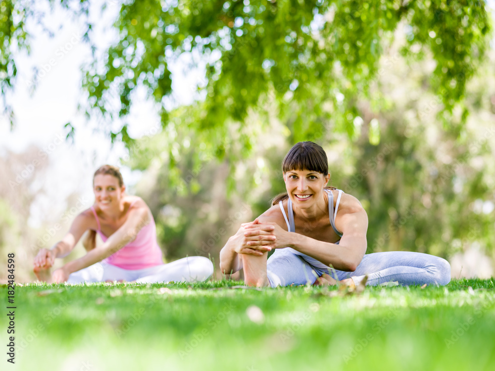 Young women exercising in the park Young women exercising in the park