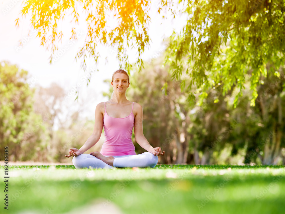 Young woman doing yoga in the park