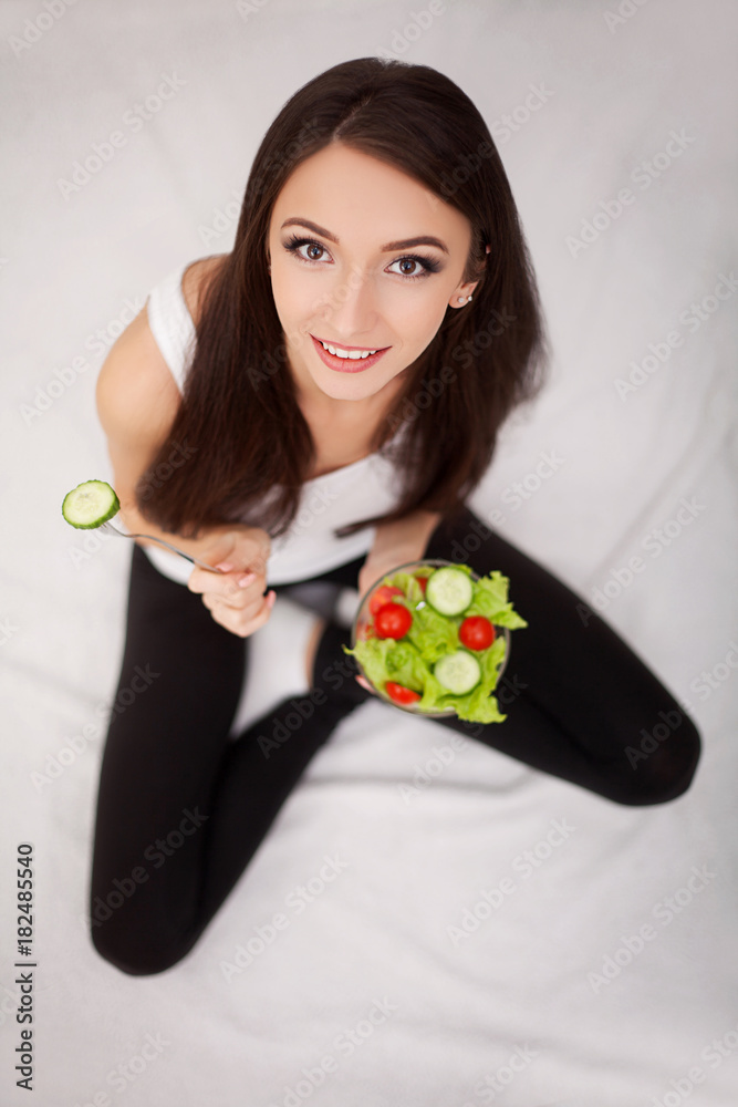 Diet. The concept of healthy and unhealthy nutrition. The model plus size makes a choice in favor of healthy food and fruit by refusing fast food and burger. XXL woman Diet. The concept of healthy and unhealthy nutrition. The model plus size makes a choice in favor of healthy food and fruit by refusing fast food and burger. XXL woman
