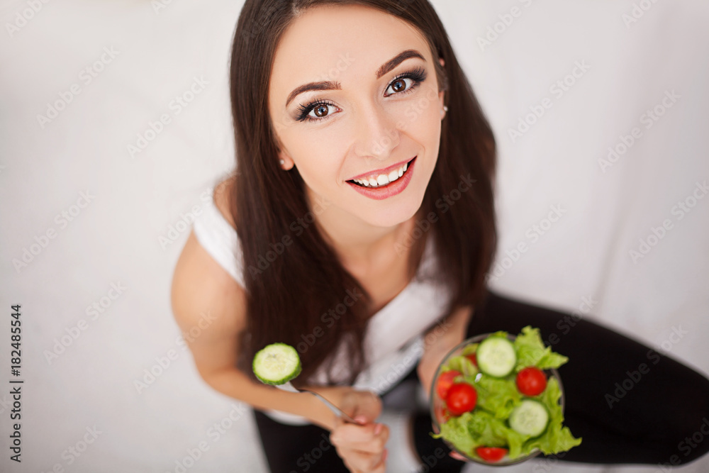 Diet. The concept of healthy and unhealthy nutrition. The model plus size makes a choice in favor of healthy food and fruit by refusing fast food and burger. XXL woman Diet. The concept of healthy and unhealthy nutrition. The model plus size makes a choice in favor of healthy food and fruit by refusing fast food and burger. XXL woman