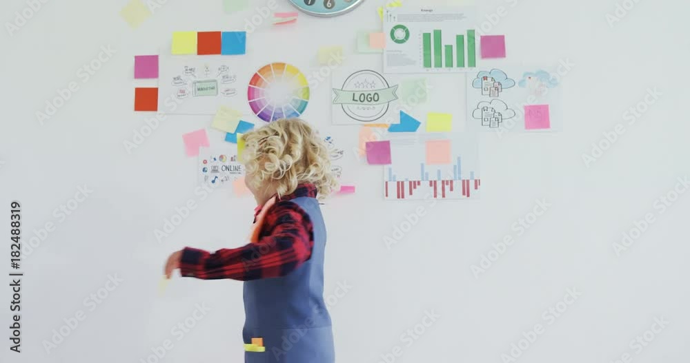 Kid as business executive with sticky notes on his body Kid as business executive with sticky notes on his body