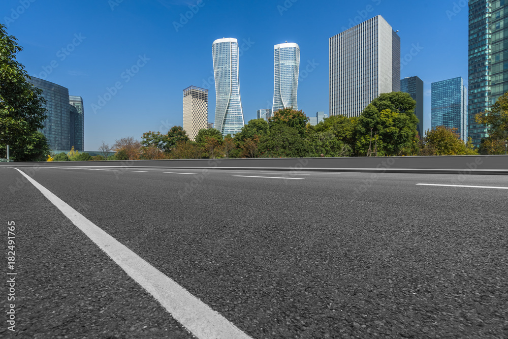 Empty asphalt road through modern city in hangzhou, China.