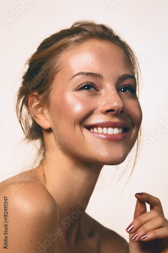 a girl smiling with nude make up photo