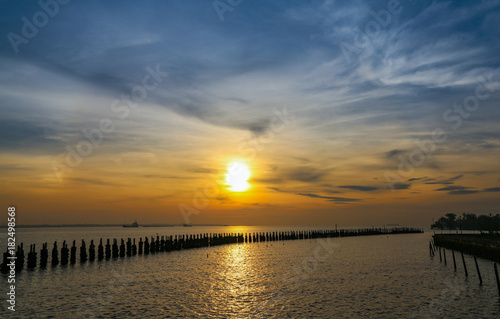 Sunrise at the sea with light on bright blue sky background