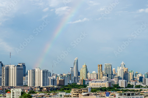 The most beautiful scene of Bangkok city during sunset. You can see beautiful rainbow above the group of buildings in the scene.
