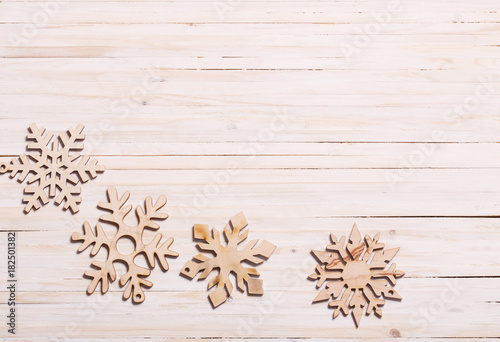 Snowflakes on wooden background