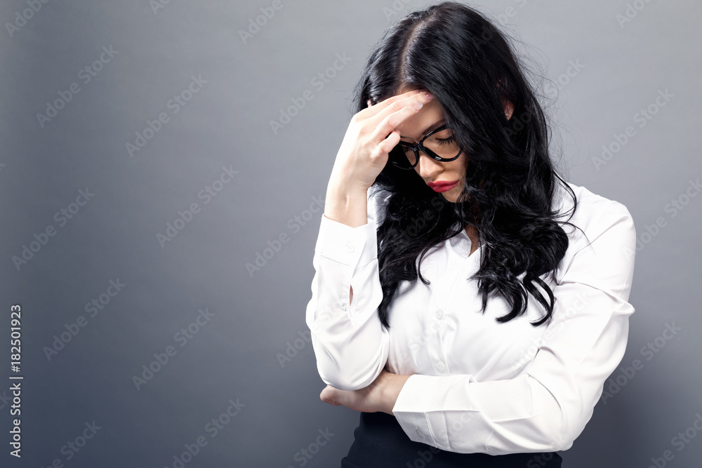 Young woman feeling stressed on a solid background Young woman feeling stressed on a solid background