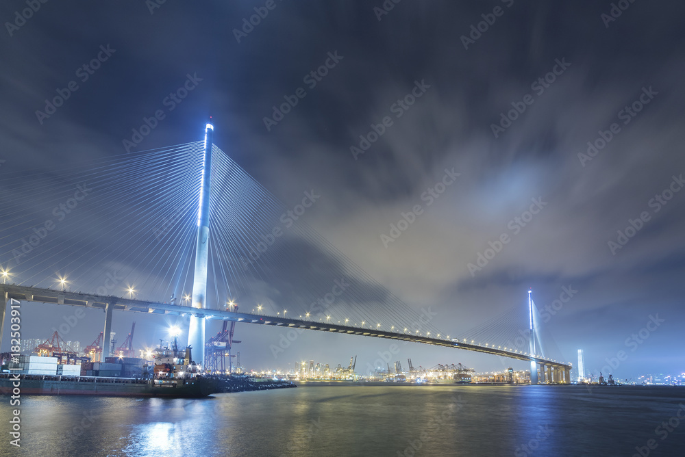 Suspension bridge in Hong Kong harbor at night