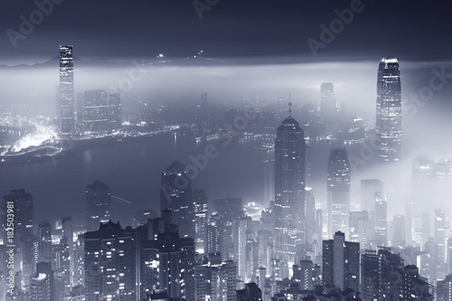 Misty night view of Victoria harbor in Hong Kong city © leeyiutung