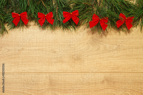 New Year / Christmas tree with red bows on the wooden background template