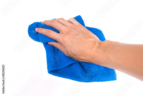 Hand and blue rag cleaning wall