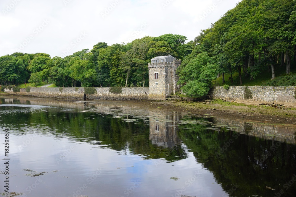 Ancient stone tower reflected in the lake