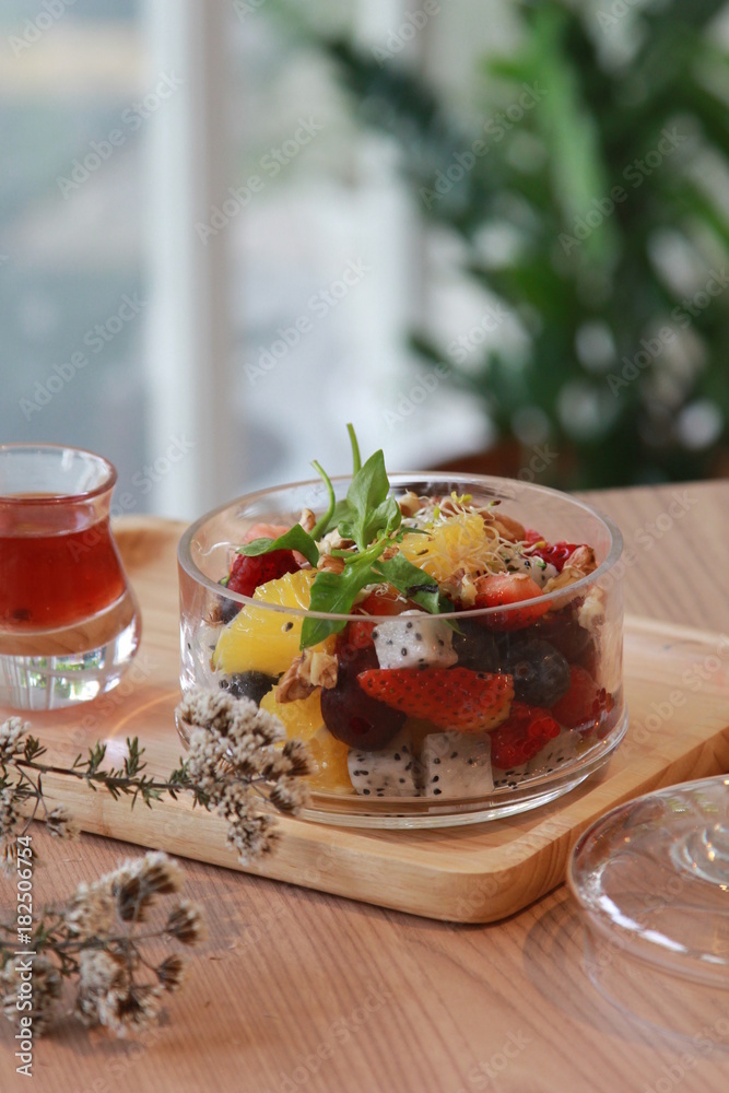 Clear bowl of sliced summer fruits on a dish towel Clear bowl of sliced summer fruits on a dish towel