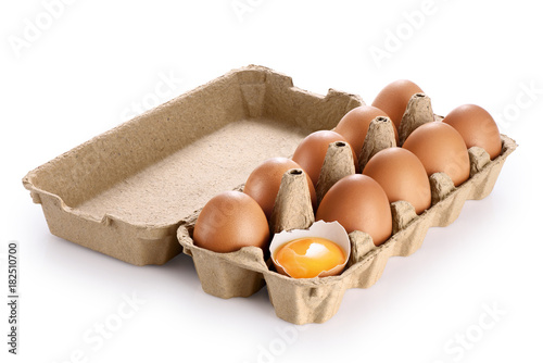 Carton egg box with eggs isolated on white background. Broken egg, yolk.