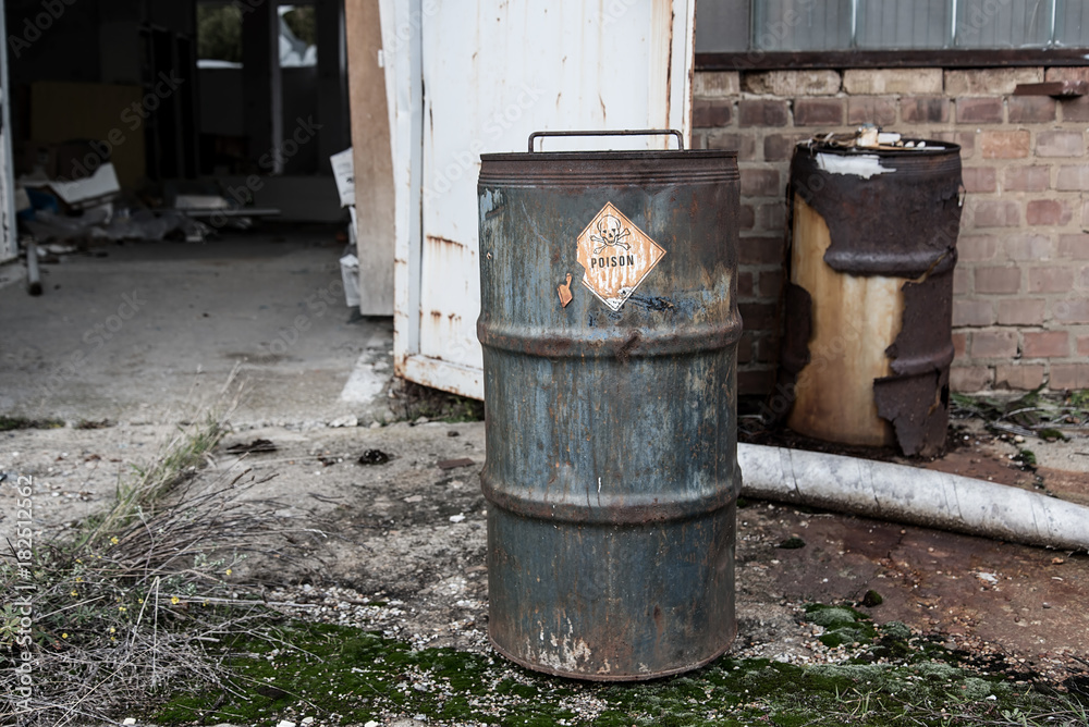 Poison symbol and text on rusty barrel Poison symbol and text on rusty barrel