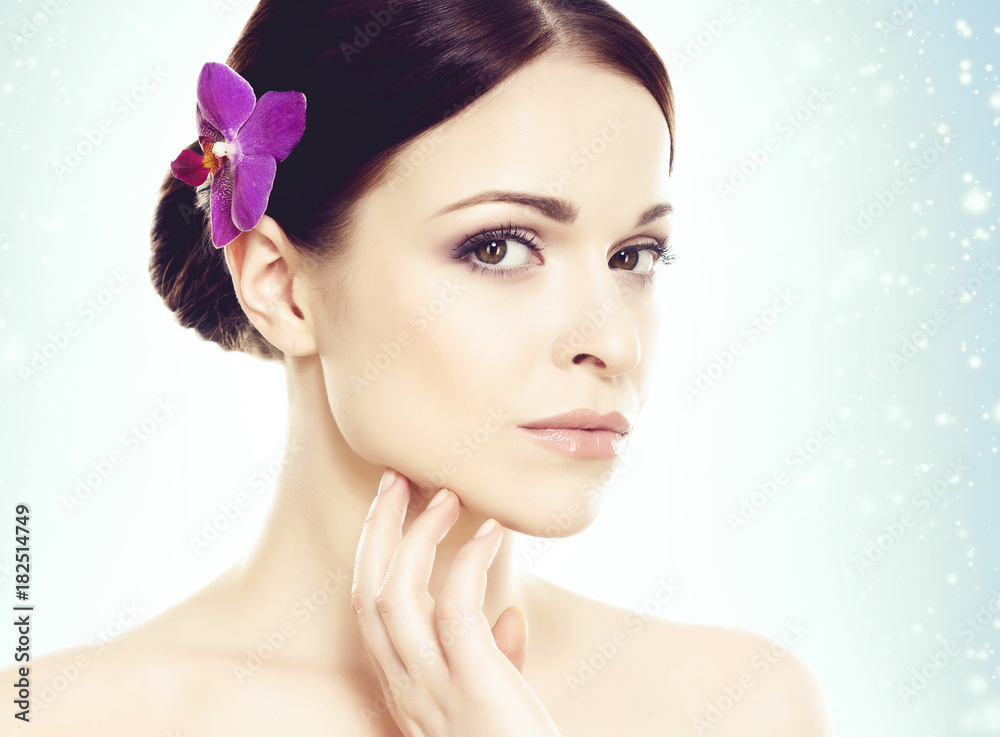 Portrait of young and beautiful girl over blue winter background with snowflakes. Christmas, health, spa, makeup, and face lifting concept. Portrait of young and beautiful girl over blue winter background with snowflakes. Christmas, health, spa, makeup, and face lifting concept.