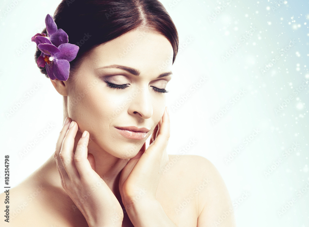 Portrait of young and beautiful girl over blue winter background with snowflakes. Christmas, health, spa, makeup, and face lifting concept. Portrait of young and beautiful girl over blue winter background with snowflakes. Christmas, health, spa, makeup, and face lifting concept.