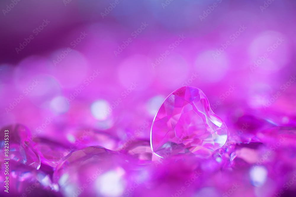 Many lilac little crystal hearts with bokeh background. Many lilac little crystal hearts with bokeh background.