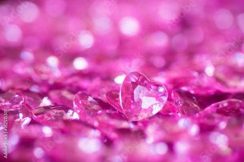 Many pink little crystal hearts with bokeh background.