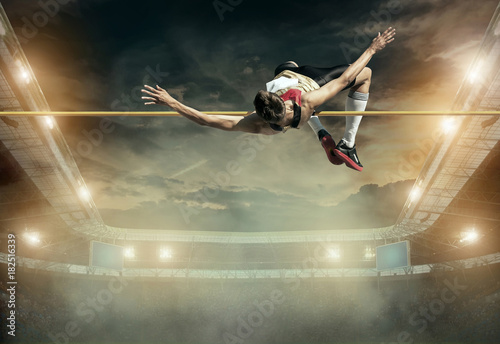 Fototapeta Naklejka Na Ścianę i Meble -  Athlete in action of high jump.