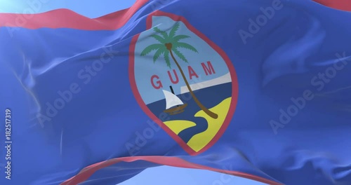 Guamanian flag waving at wind in slow in blue sky, loop photo