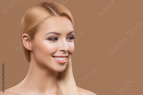 portrait of beautiful blonde long hair girl isolated on beige