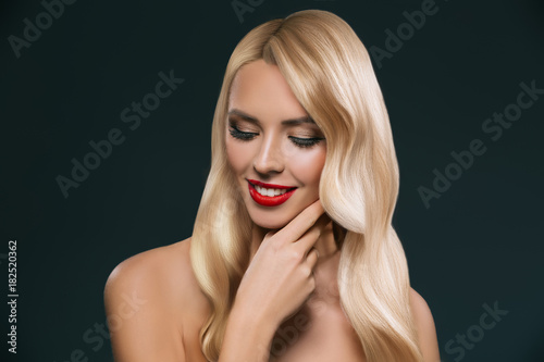 portrait of beautiful blonde hair girl with makeup isolated on black