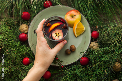 Hand taking cup with homemade mulled wine. © dturphoto