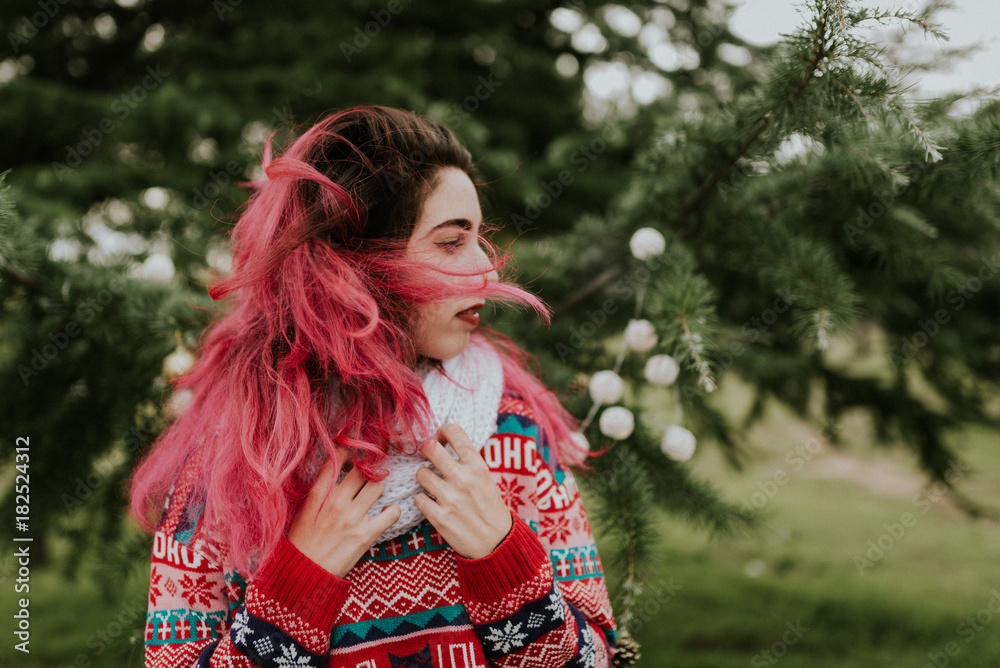 Beautiful woman near decorated conifer Beautiful woman near decorated conifer