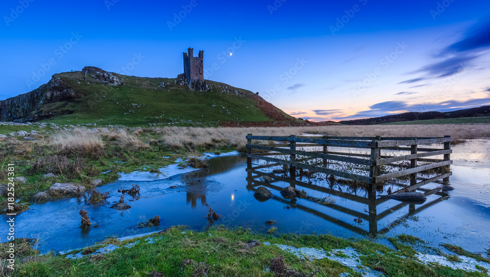 Dunstanburgh Castle ruins on a cold frosty Autumn evening, County of Northumbeland, England
