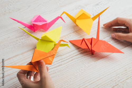 Orange and yellow paper origami figures. Top view. 