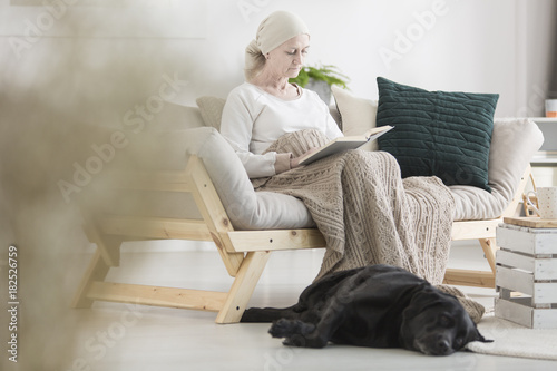 Sick woman reading book © Photographee.eu