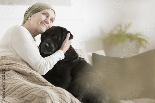 Sick woman hugging her pet