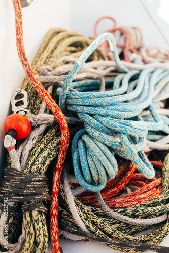 Running and rigging of nautical marine ropes pile on yacht or sailboat deck, strong and resistant cords, dyneema and spectra