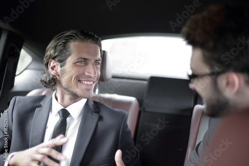 business partners sitting on the backseat of the car © ASDF